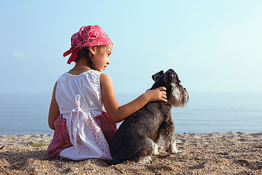 beautiful little girls embracing her dog